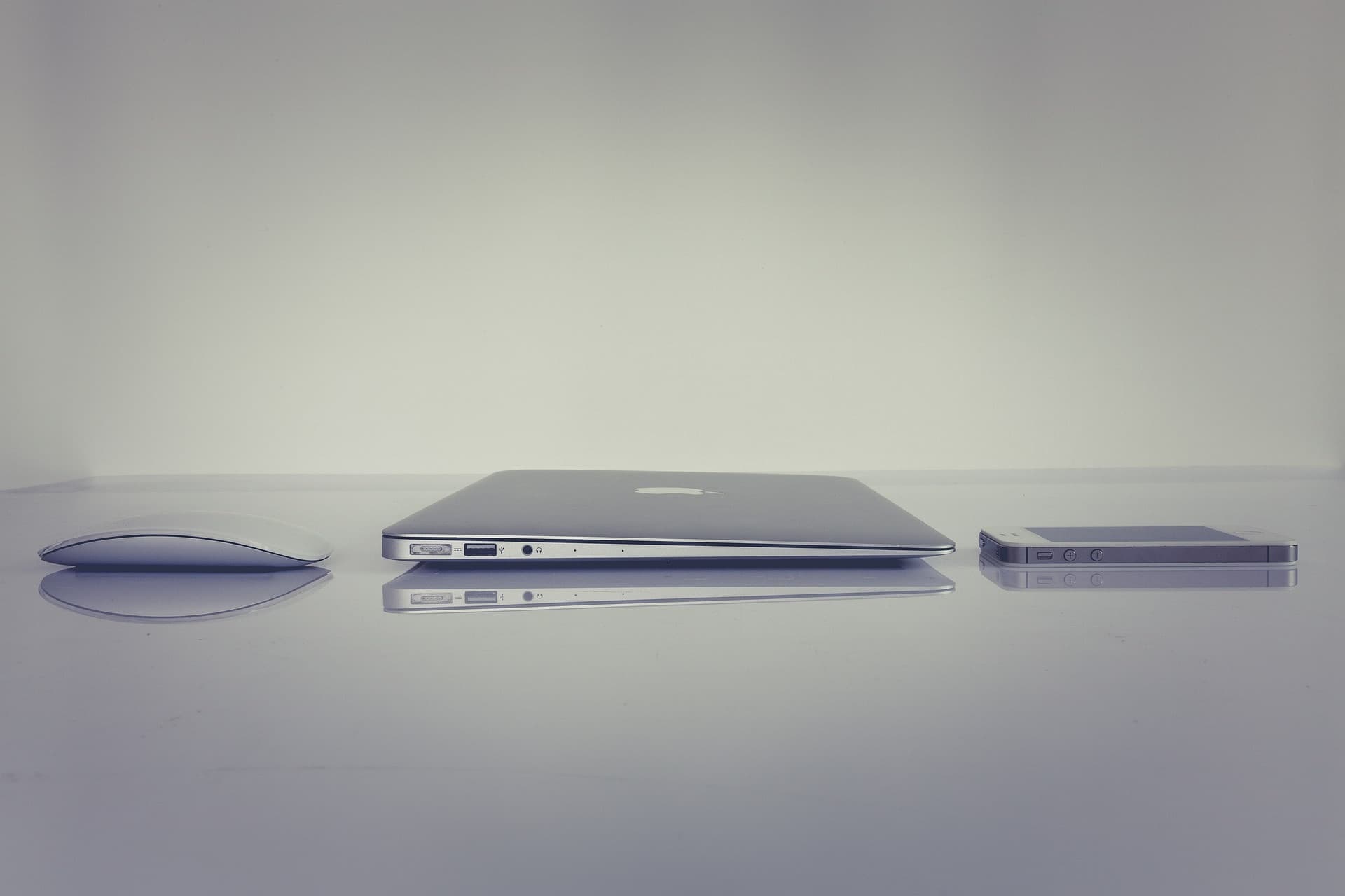 Laptop, mouse and phone on a desk